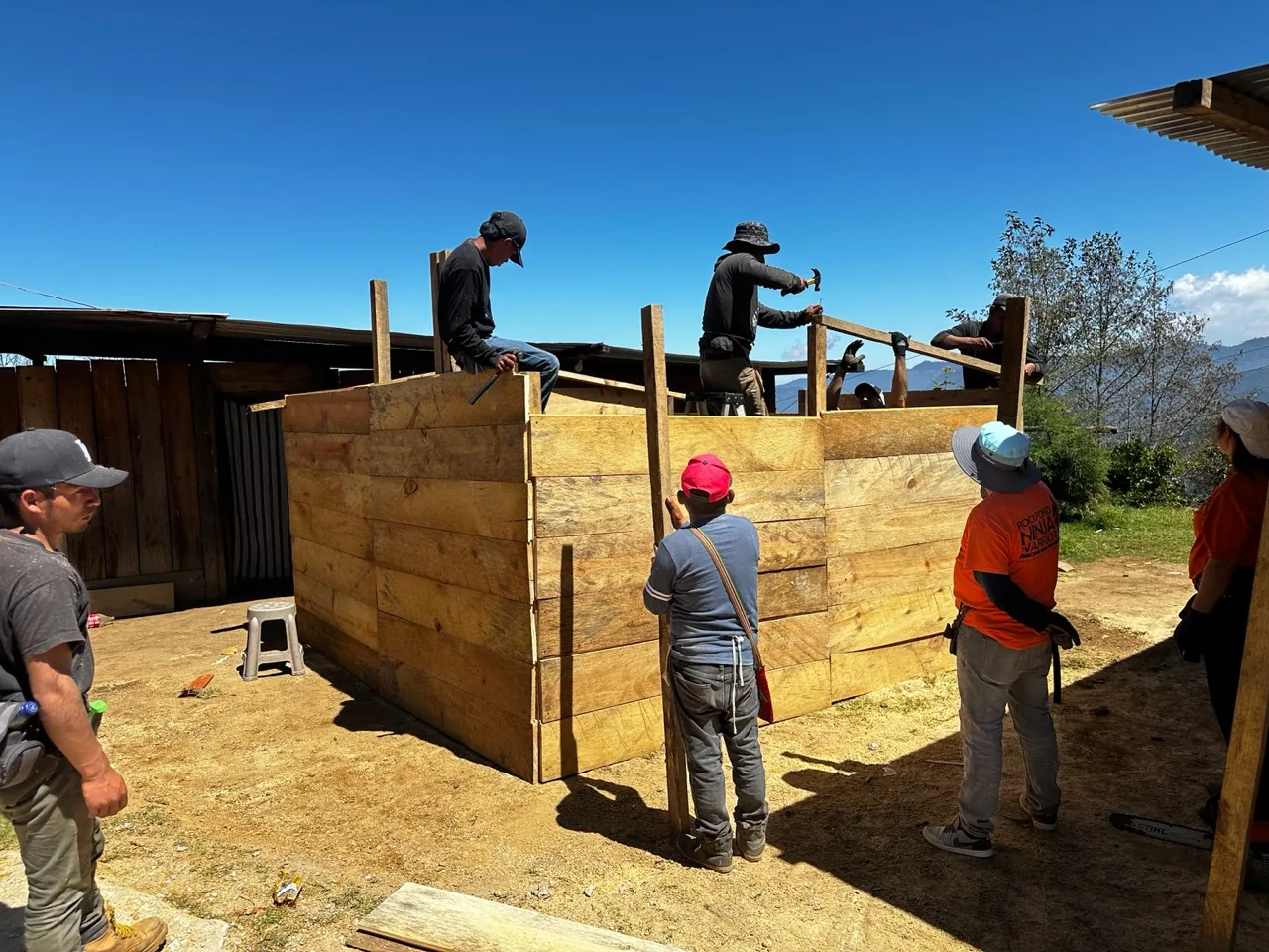Volunteer crew building a wooden house in Guatemala's Ixil region.