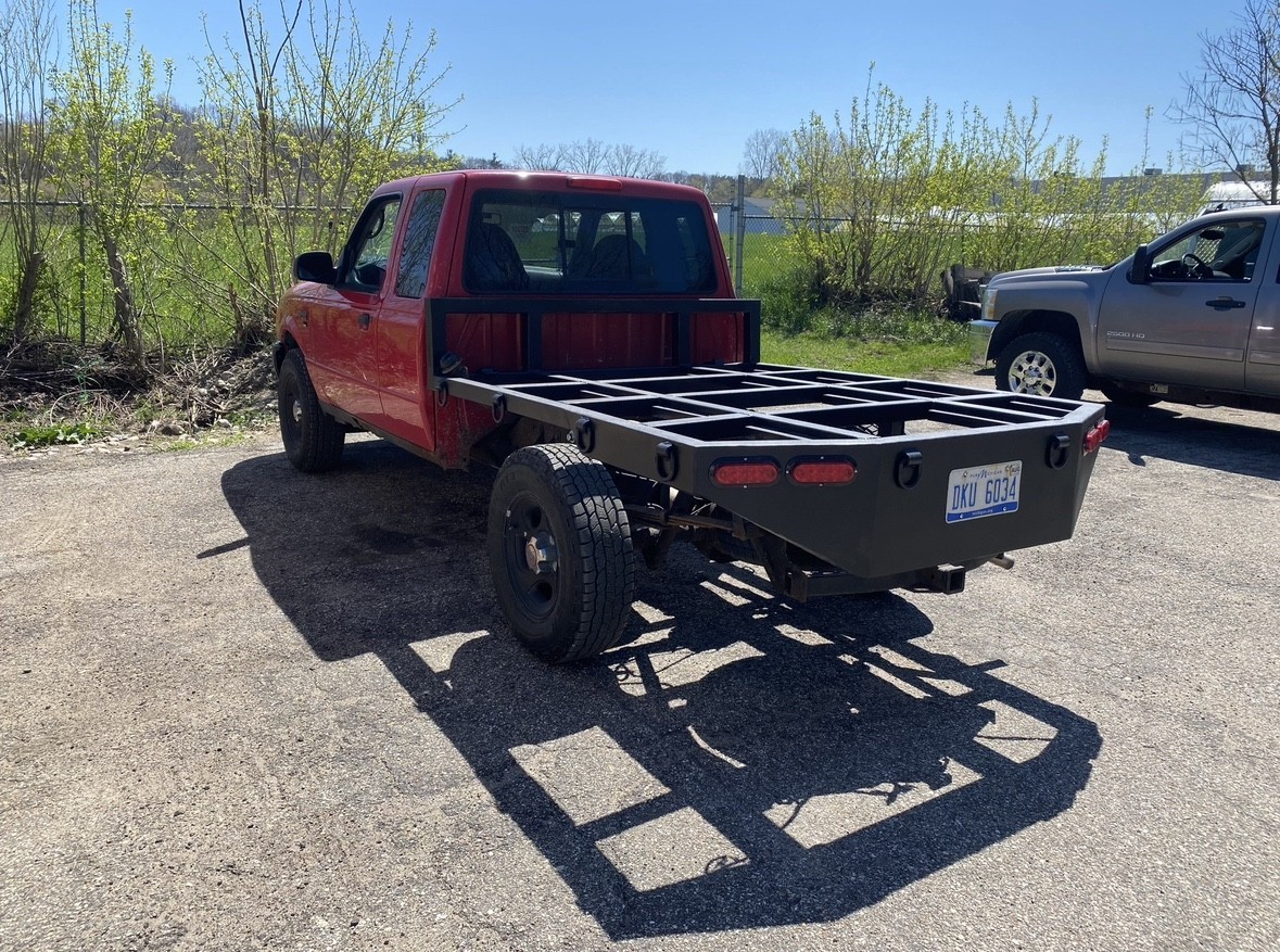 Permanent Ford Ranger flatbed installed on the truck, viewed from the rear