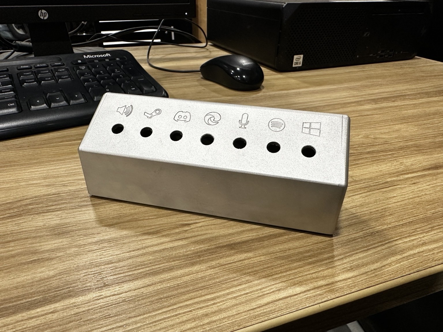 Machined aluminum rotary volume controller enclosure on a desk